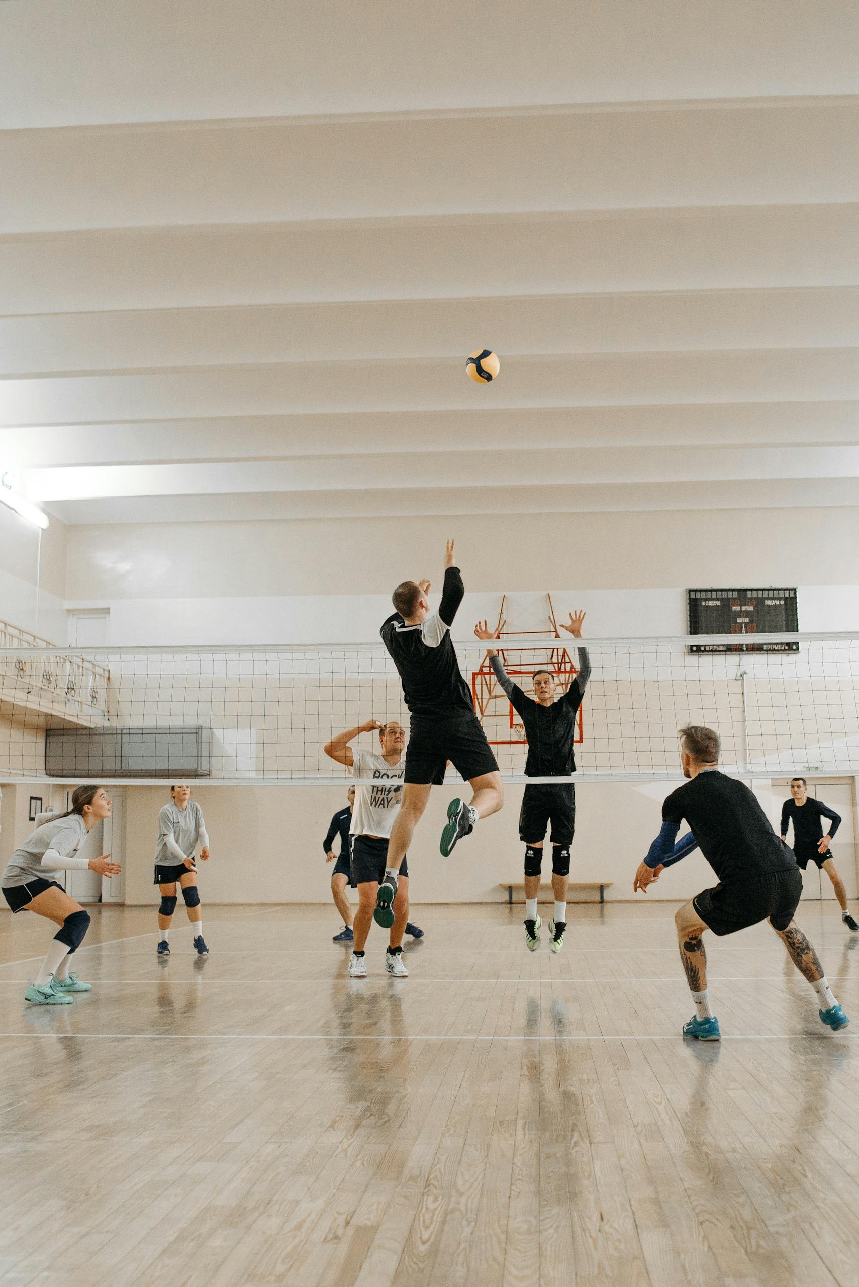 Photo by Pavel Danilyuk Male athletes compete fiercely in an indoor volleyball match.